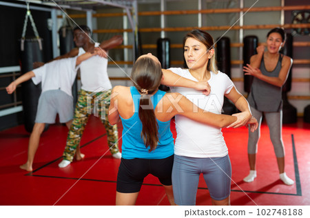 People sparring during self-defence group training 102748188