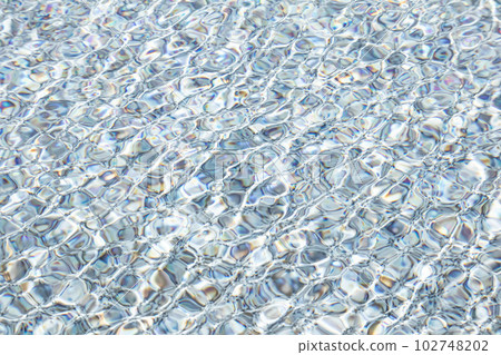 The surface of the water bathed in the sun and swaying in the wind 102748202