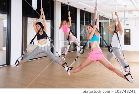 People training trx pilates at group class 102748241