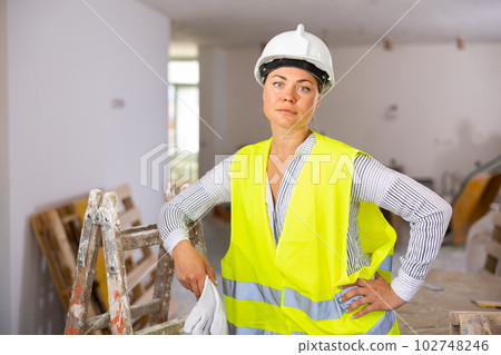 Confident female civil engineer standing inside building under construction Confident female civil engineer standing inside building under construction 102748246