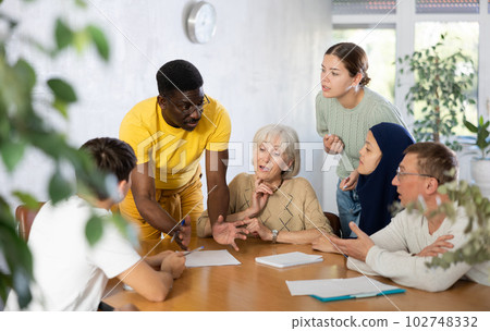 Group of multinational people making notes at table 102748332