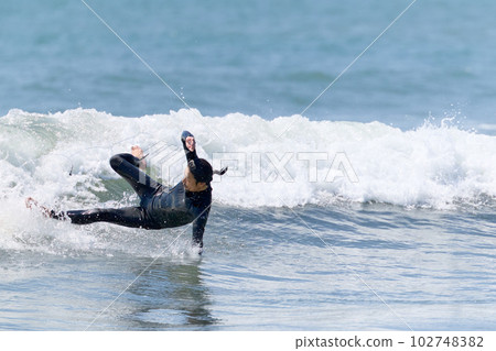 Man enjoying surfing Moment of wipeout 102748382