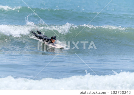 Woman surfing on a sunny day 102750243