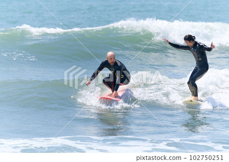 Two men enjoying surfing 102750251