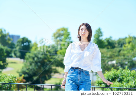Woman bathing in light outdoors Woman bathing in light outdoors 102750331