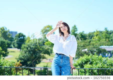 Woman bathing in light outdoors Woman bathing in light outdoors 102750336