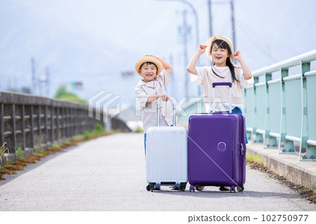A smiling child with a suitcase travel A smiling child with a suitcase travel 102750977