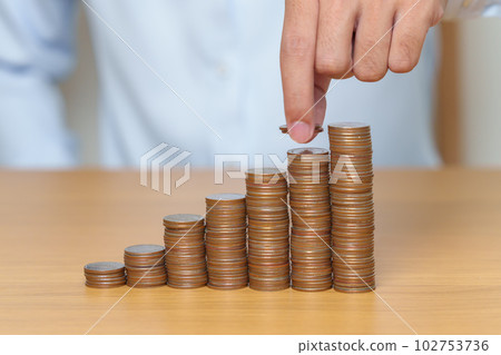 Money Saving for Future Plan, Retirement fund, Pension, Investment, Wealth Business and Financial concepts. hand putting coin into stack on table, Money counting and stack arrangement for deposit Money Saving for Future Plan, Retirement fund, Pension, Investment, Wealth Business and Financial concepts. hand putting coin into stack on table, Money counting and stack arrangement for deposit 102753736
