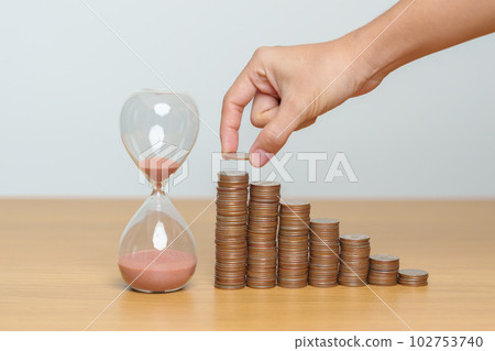 Money Saving for Future Plan, Retirement fund, Pension, Investment, Wealth Business and Financial concepts. hand putting coin on money stack with sandglass Money Saving for Future Plan, Retirement fund, Pension, Investment, Wealth Business and Financial concepts. hand putting coin on money stack with sandglass 102753740