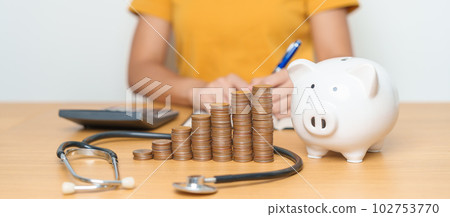 Money Saving, Health Insurance, Medical, Donation and Financial concepts. woman with coins stack and piggy bank and stethoscope, Money stack Counting arrangement for deposit and Healthcare cost Money Saving, Health Insurance, Medical, Donation and Financial concepts. woman with coins stack and piggy bank and stethoscope, Money stack Counting arrangement for deposit and Healthcare cost 102753770