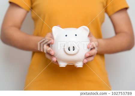 Money Saving for Future Plan, Retirement fund, Pension, Investment, Wealth Business and Financial concepts. hand holding piggy bank, Money Counting for World Savings day and Donate Money Saving for Future Plan, Retirement fund, Pension, Investment, Wealth Business and Financial concepts. hand holding piggy bank, Money Counting for World Savings day and Donate 102753789