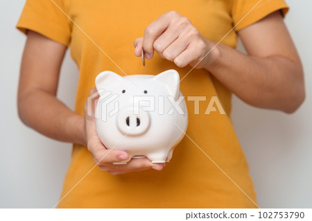 Money Saving for Future Plan, Retirement fund, Pension, Investment, Wealth Business and Financial concepts. hand holding and putting into piggy bank, Money Counting for World Savings day and Donate Money Saving for Future Plan, Retirement fund, Pension, Investment, Wealth Business and Financial concepts. hand holding and putting into piggy bank, Money Counting for World Savings day and Donate 102753790