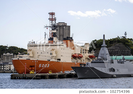 Antarctic research icebreaker Shirase and stealth destroyer Kumano anchored at Maritime Self-Defense Force Yokosuka base 102754396