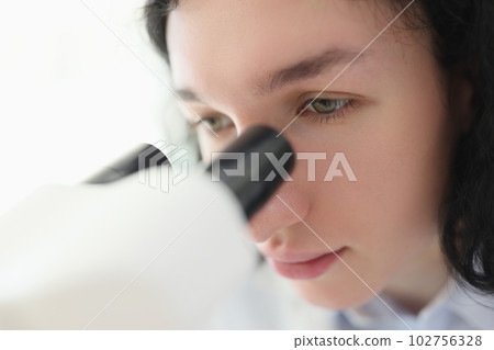 Laboratory worker checks sample using electronic microscope Laboratory worker checks sample using electronic microscope 102756328