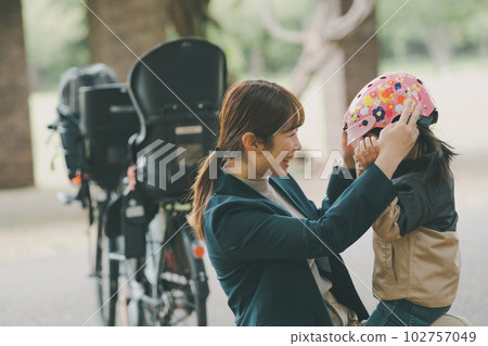 Wearing a bicycle helmet Wearing a bicycle helmet 102757049