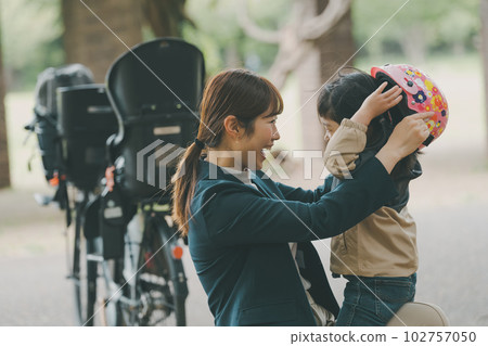 Wearing a bicycle helmet Wearing a bicycle helmet 102757050