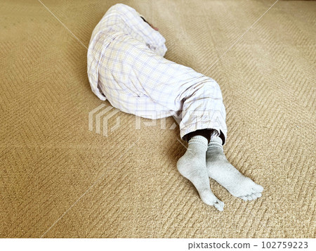 A woman lying in a nightgown _ from her feet A woman lying in a nightgown _ from her feet 102759223
