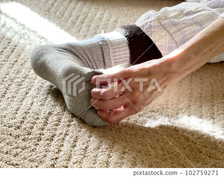 老婦人的手拉著腳趾穿襪子 102759271