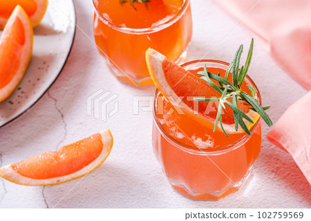 Hard seltzer with grapefruit soda and rosemary in glasses on the table 102759569