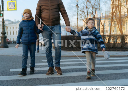 father and children crossing road on pedestrian crosswalk father and children crossing road on pedestrian crosswalk 102760372
