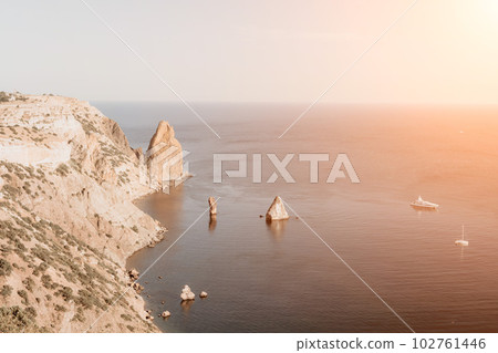 Aerial view from above on calm azure sea and volcanic rocky shores. Small waves on water surface in motion blur. Nature summer ocean sea beach background. Nobody. Holiday, vacation and travel concept Aerial view from above on calm azure sea and volcanic rocky shores. Small waves on water surface in motion blur. Nature summer ocean sea beach background. Nobody. Holiday, vacation and travel concept 102761446