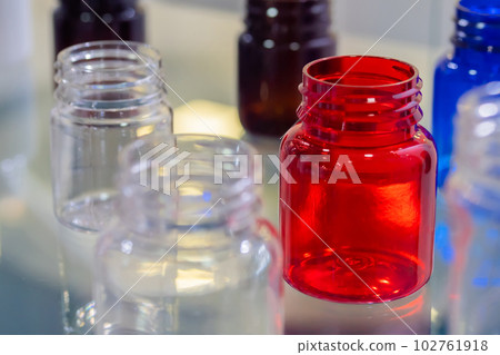 Medical empty glass bottles in showcase at pharmaceutical exhibition 102761918