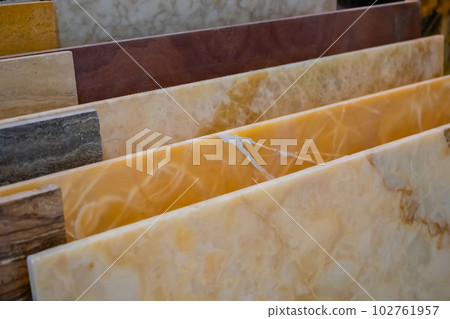 Colorful granite and marble stone slabs on counter for sale at hardware store Colorful granite and marble stone slabs on counter for sale at hardware store 102761957