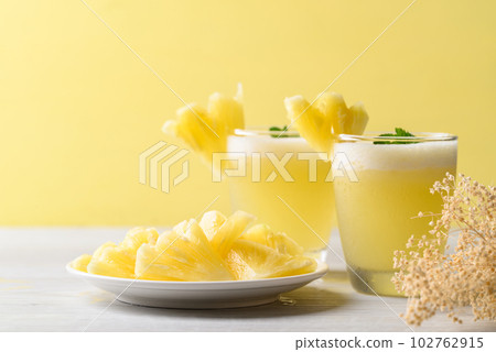 Pineapple smoothie in glass with sliced pineapple fruit, Tropical summer drink 102762915