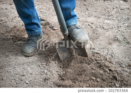 Leg with a shovel. Man digging 102763368