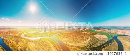 Panorama Aerial View Green Forest Woods And River Landscape In Sunny Spring Summer Day. Sunshine, Top View Of Nature, Bird's Eye View. Trees Standing In Water During Spring Flood floodwaters. woods in Panorama Aerial View Green Forest Woods And River Landscape In Sunny Spring Summer Day. Sunshine, Top View Of Nature, Bird's Eye View. Trees Standing In Water During Spring Flood floodwaters. woods in 102763541