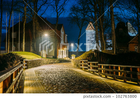 Kuressaare, Saaremaa Island, Estonia. Cabble Stone Road Near Episcopal Castle In Night Illuminations. Amazing Bold Bright Blue Starry Sky Gradient. Travel To Estonia Kuressaare, Saaremaa Island, Estonia. Cabble Stone Road Near Episcopal Castle In Night Illuminations. Amazing Bold Bright Blue Starry Sky Gradient. Travel To Estonia 102763800