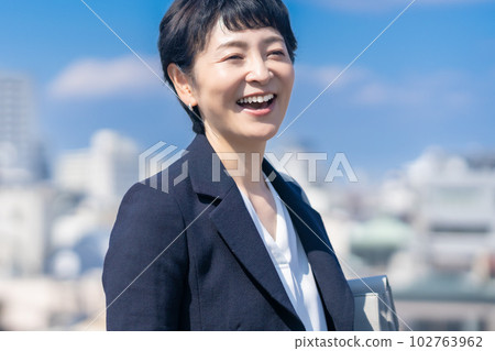 Female career woman in her 50s wearing a jacket Female career woman in her 50s wearing a jacket 102763962