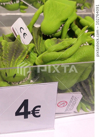 Close-up of toy dinosaurs on store shelves. 102764091