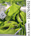 Close-up of toy dinosaurs on store shelves. 102764092