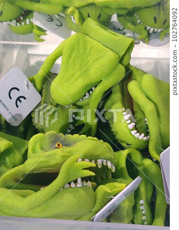 Close-up of toy dinosaurs on store shelves. Close-up of toy dinosaurs on store shelves. 102764092