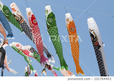 A flock of carp streamers swimming in the blue sky of May A flock of carp streamers swimming in the blue sky of May 102764403
