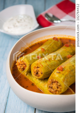 Recipe of stuffed courgette with tomato sauce, Lebanese style, Kouca Mehchi bi Banadoura, with Greek Recipe of stuffed courgette with tomato sauce, Lebanese style, Kouca Mehchi bi Banadoura, with Greek 102764412