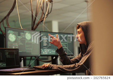 Hacker coding computer virus, writing password cracking script, programming malicious software. Cyberattack, data breach, woman developing malware at night time, cybercrime Hacker coding computer virus, writing password cracking script, programming malicious software. Cyberattack, data breach, woman developing malware at night time, cybercrime 102765624