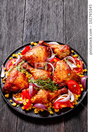roast chicken with corn and tomatoes on plate roast chicken with corn and tomatoes on plate 102765845