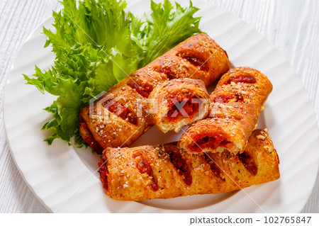 chorizo and semi-dried tomato puff pastry rolls chorizo and semi-dried tomato puff pastry rolls 102765847