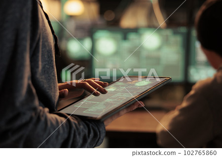 Database illegal access, hacker using spyware on digital tablet, computer system password cracking. Cyberattack, internet thieves stealing financial data, breaking into online server Database illegal access, hacker using spyware on digital tablet, computer system password cracking. Cyberattack, internet thieves stealing financial data, breaking into online server 102765860