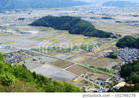 View of Nagahama with paddy fields overlooking Mt. Shizugatake 102766276