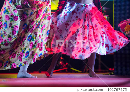 Young dancer woman barefoot in gypsy dress dancing on stage 102767275