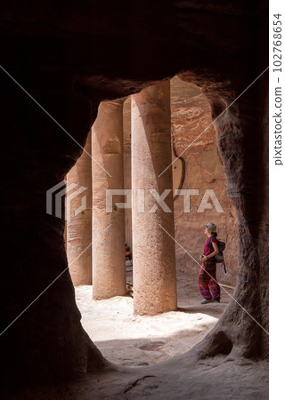 Tourist woman visiting a tomb in Petra, Jordan 102768654