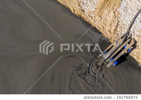 Aerial view of mining residual waters from a copper mine discharging into decanting pond. Geamana, Romania 102768855