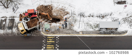 Heavy construction equipment during excavation at construction 102768986