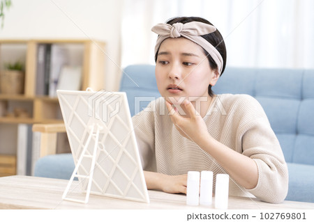 A young woman suffering from skin problems 102769801