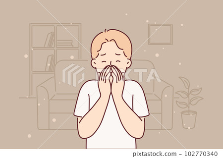 Little boy allergic to dust sneezes and suffers from runny nose standing in untidy room Little boy allergic to dust sneezes and suffers from runny nose standing in untidy room 102770340
