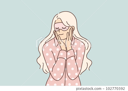 Woman in pajamas and sleep mask smiles getting ready for night rest after hard day work Woman in pajamas and sleep mask smiles getting ready for night rest after hard day work 102770392