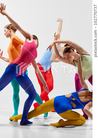 Cropped, close-up image of young girl. ballerinas in bright, multicolored tights and bodysuits dancing over grey background Cropped, close-up image of young girl. ballerinas in bright, multicolored tights and bodysuits dancing over grey background 102770737